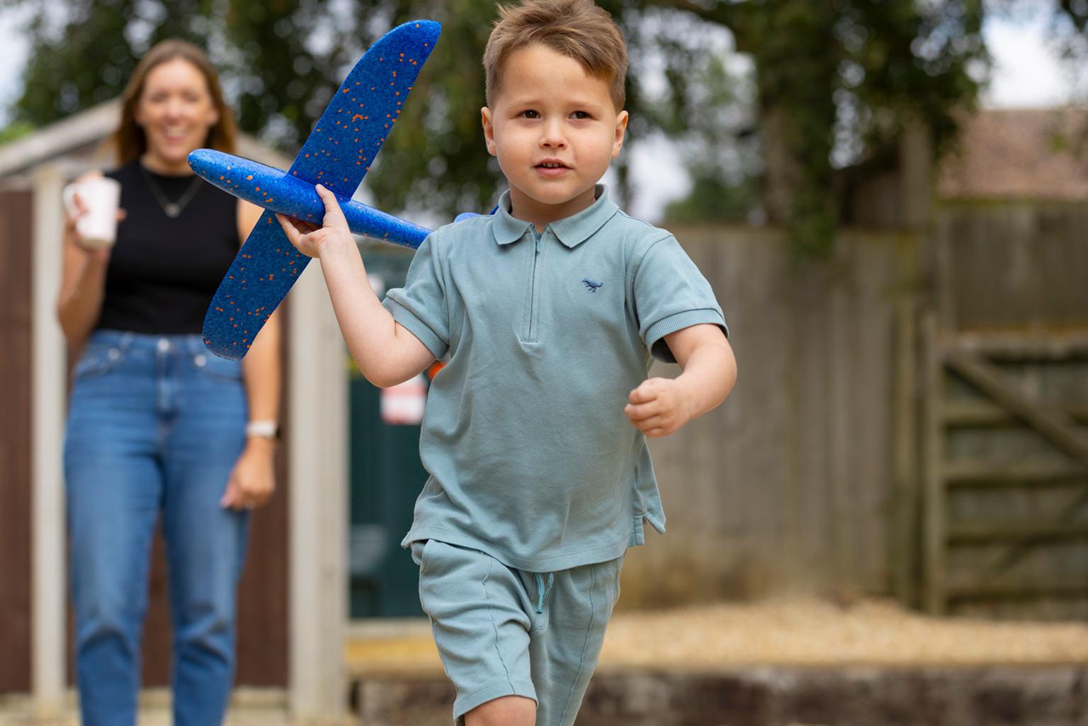 foster_with_peterborough_hero_image_of_fostered_boy_throwing_a_toy_aeroplane